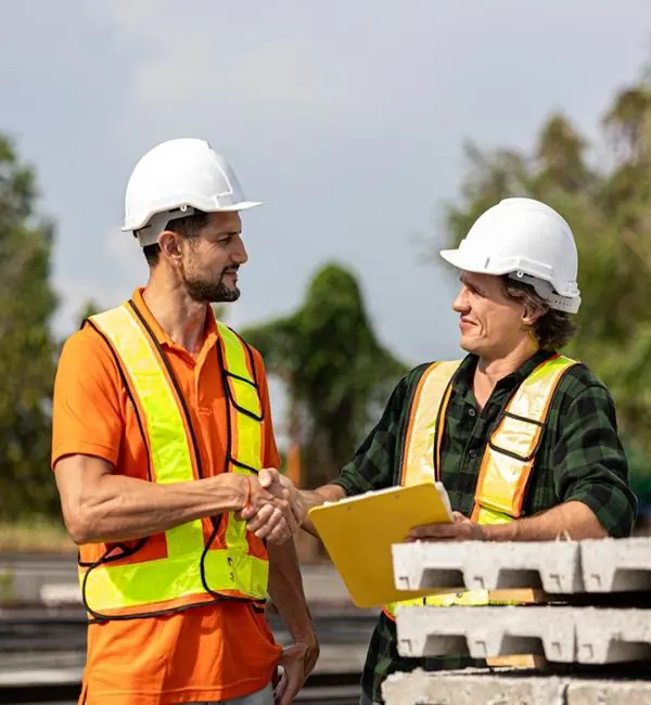 Construction professionals shaking hands after planning a project